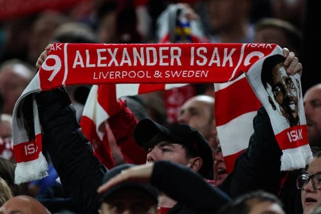 Liverpool, England, 17th September 2025. A Liverpool fan holds a scarf with Alexander Isak of Liverpool on it during the Liverpool vs Atletico Madrid UEFA Champions League match at Anfield, Liverpool. Picture credit should read: James Baylis Sportimage EDITORIAL USE ONLY. No use with unauthorised audio, video, data, fixture lists, club league logos or live services. Online in-match use limited to 120 images, no video emulation. No use in betting, games or single club league player publications. SPI_018_JB_LIV_ATM_ SPI-4140-0018