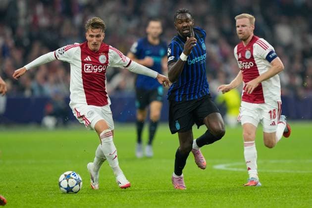 AMSTERDAM, 23-08-2025, Johan Cruijff ArenA ,season 2025 2026 , UEFA Champions League football , league phase, .Match between Ajax and Inter Milan , Picture shows Ajax player Mika Godts, Inter player Marcus Thuram Ajax - Inter  x31066395x Copyright: