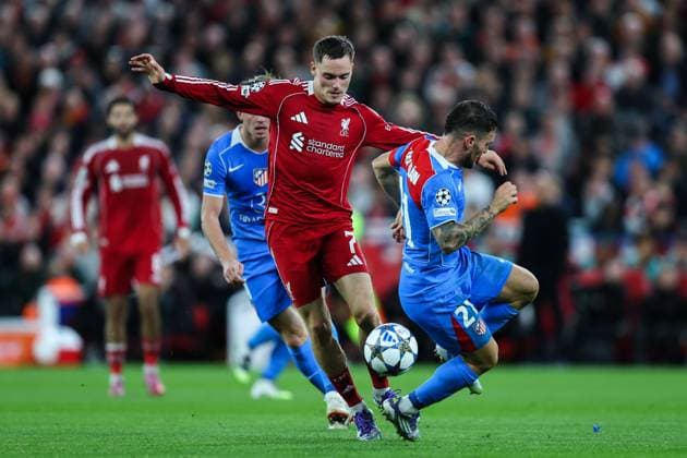 Liverpool, England, 17th September 2025. Florian Wirtz of Liverpool gets the better of Javi Galan of Atletico Madrid during the Liverpool vs Atletico Madrid UEFA Champions League match at Anfield, Liverpool. Picture credit should read: James Baylis Sportimage EDITORIAL USE ONLY. No use with unauthorised audio, video, data, fixture lists, club league logos or live services. Online in-match use limited to 120 images, no video emulation. No use in betting, games or single club league player publications. SPI_050_JB_LIV_ATM_ SPI-4140-0050