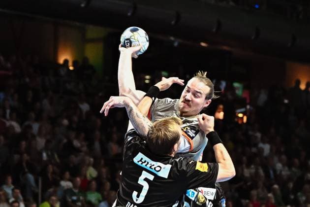 18 09 2025, xlakx, Handball, EHF Champions League, Fuechse Berlin Aalborg Handbold v l Max Darj Fuechse Berlin , Lukas Nilsson Aalborg Handbold goes for a jump shot Berlin Daniel Lakomski