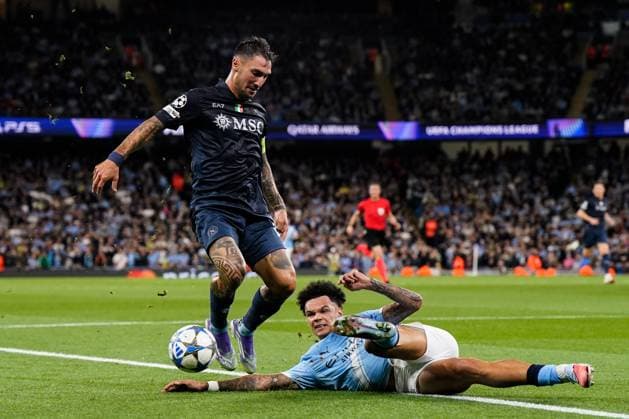 Manchester, England, 18th September 2025. Nico O™Reilly of Manchester City tackles Matteo Politano of SSC Napoli during the Manchester City vs Napoli UEFA Champions League match at the Etihad Stadium, Manchester. Picture credit should read: Andrew Yates Sportimage EDITORIAL USE ONLY. No use with unauthorised audio, video, data, fixture lists, club league logos or live services. Online in-match use limited to 120 images, no video emulation. No use in betting, games or single club league player publications. SPI_032_AY_MCI_NAP SPI-4144-0064