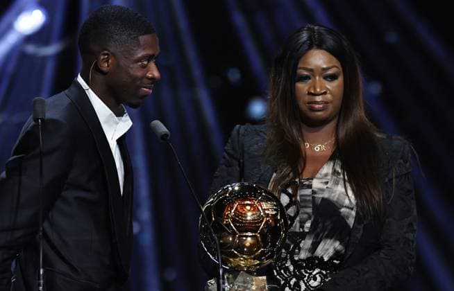 (250923) -- PARIS, Sept. 23, 2025 -- Paris Saint-Germain s French player Ousmane Dembele (L) and his mother react after winning the men s Ballon d Or awards during the 2025 Ballon d Or France Football award ceremony at the Theatre du Chatelet in Paris, France, on Sept. 22, 2025. ) (SP)FRANCE-PARIS-FOOTBALL-BALLON D OR CEREMONY GaoxJing 