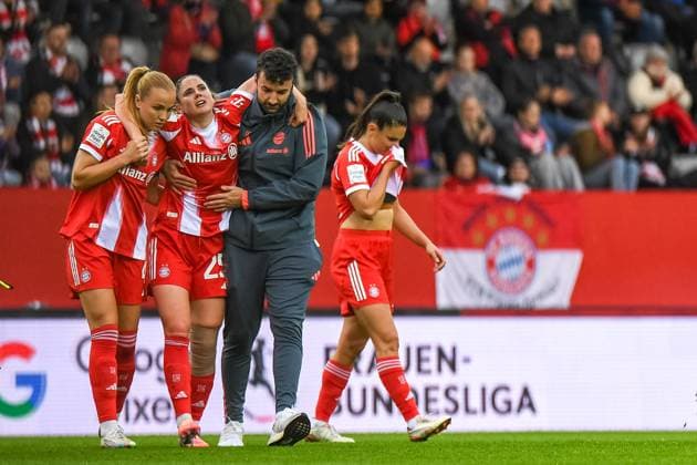 Glodis Viggosdottir 4 FC Bayern supports her teammate Sarah Zadrazil 25 FC Bayern after a foul during the Google Pixel Womens Bundesliga match FC Bayern Munich SC Freiburg on 23 09 2025 Munich FC Bayern Campus Bayern Germany
