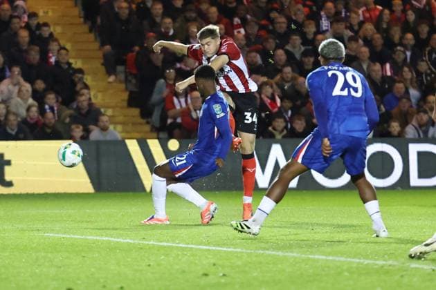 Lincoln City v Chelsea EFL Cup 23 09 2025. Lincoln City forward Freddie Draper (34) ghets a shot away during the EFL Cup match between Lincoln City and Chelsea at Sincil Bank, Lincoln, United Kingdom on 23 September 2025. Lincoln Sincil Bank Lincs United Kingdom Editorial use only DataCo restrictions apply See www.football-dataco.com , Copyright: xJohnxMallettx PSI-22888-0023