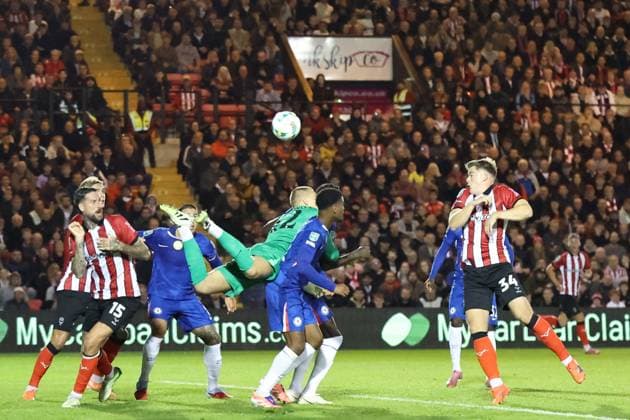 Lincoln City v Chelsea EFL Cup 23 09 2025. Chelsea goalkeeper Filip Jorgensen (12) misses his punch during the EFL Cup match between Lincoln City and Chelsea at Sincil Bank, Lincoln, United Kingdom on 23 September 2025. Lincoln Sincil Bank Lincs United Kingdom Editorial use only DataCo restrictions apply See www.football-dataco.com , Copyright: xJohnxMallettx PSI-22888-0034