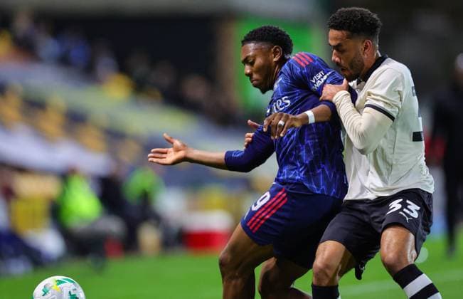24th September 2025; Vale Park, Stoke, Staffordshire, England; EFL Carabao Cup Football, Port Vale versus Arsenal; Myles Lewis-Skelly of Arsenal under pressure from George Hall of Port Vale  RogerxEvans