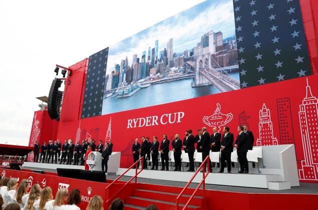 Members of Team Europe and Team United States stand on stage during the opening ceremony for the 45th Ryder Cup at The Black Course at Bethpage State Park in Farmingdale, New York, on Wednesday, September 24, 2025. The three-day golf tournament starts on Friday, September 26, 2025.  RYD20250924836 JOHNxANGELILLO