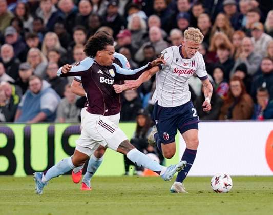 Birmingham, England, 25th September 2025. Boubacar Kamara of Aston Villa tackles Jens Odgaard of Bologna during the Aston Villa vs Bologna UEFA Europa League match at Villa Park, Birmingham. Picture credit should read: Andrew Yates Sportimage EDITORIAL USE ONLY. No use with unauthorised audio, video, data, fixture lists, club league logos or live services. Online in-match use limited to 120 images, no video emulation. No use in betting, games or single club league player publications. SPI_020_AY_Villa_Bologna SPI-4162-0020