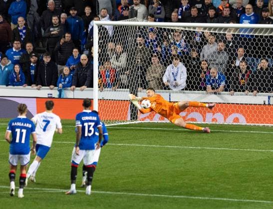 Jack Butland of Rangers saves a penalty from Oh Hyeon-Gyu of KRC Genk during UEFA Europa League league phase match at Ibrox Stadium, Glasgow. Rangers v KRC Genk - UEFA Europa League - Ibrox Stadium, Glasgow, Lanarkshire, Scotland, UK - 25 Sep 2025Glasgow Ibrox Stadium Lanarkshire, Scotland United Kingdom EDITORIAL USE ONLY  Copyright: xRangersxFC Shutterstockx 15504638am