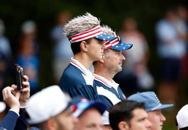 Fans wear hats with the colors os the United States flag at the 45th Ryder Cup at The Black Course at Bethpage State Park in Farmingdale, New York on Friday, September 26, 2025. Europe is the current holder of the Ryder Cup after its win over the United States in 2023 at Marco Simone Golf and Country Club.  RYD202509261009 JOHNxANGELILLO
