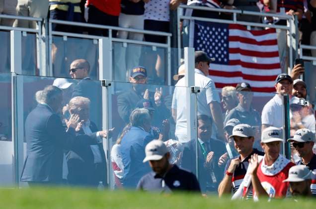 President Donald Trump gives a thumbs up as Team United States players walk onto the first hole for four-ball competition against Team Europe on day one of the 45th Ryder Cup at The Bethpage Black Course in Farmingdale, New York on Friday, September 26, 2025. Europe has taken an early 3-1 lead after the finish of the morning day one foursomes matches.  RYD20250926809 JOHNxANGELILLO