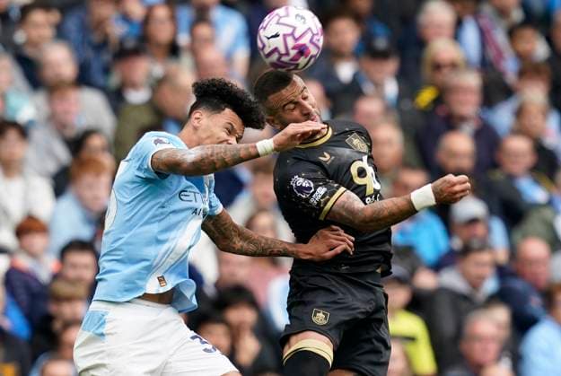 Manchester, England, 27th September 2025. Nico O™Reilly of Manchester City (L) is challenged by Kyle Walker of Burnley during the Manchester City vs Burnley Premier League match at the Etihad Stadium, Manchester. Picture credit should read: Andrew Yates Sportimage EDITORIAL USE ONLY. No use with unauthorised audio, video, data, fixture lists, club league logos or live services. Online in-match use limited to 120 images, no video emulation. No use in betting, games or single club league player publications. SPI_008_AY_MAN_CITY_BURNLEY SPI-4169-0008