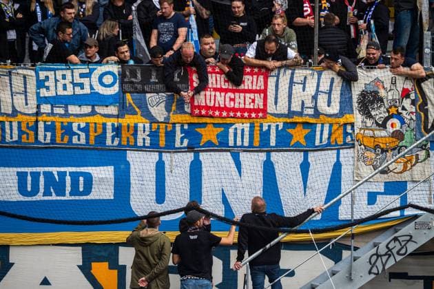 Jena , 270925, Soccer Regionalliga , FC Carl Zeiss Jena vs Chemnitzer FC in the picture Fans Ultras Jena Horda provoke interruption of the game by blocking two escape gates with banners and fans in the block