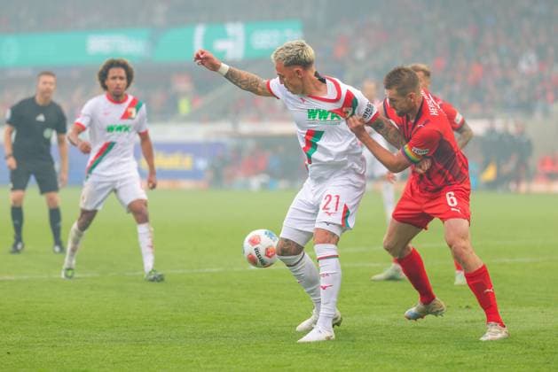 Phillip Tietz 21, FC Augsburg and Patrick Mainka 6, 1 FC Heidenheim at the match between 1 FC Heidenheim v FC Augsburg, Football, Men, Bundesliga, 2025 2026, Matchday 5 on 27 09 2025 in Heidenheim an der Brenz, Voith Arena DFL and DFB regulations prohibit any use of photographs as image sequences and or quasi video Baden Württemberg Germany