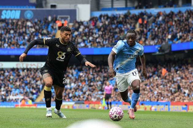 27th September 2025; Etihad Stadium, Manchester, England; Premier League Football, Manchester City versus Burnley; Jeremy Doku of Manchester City takes on Josh Laurent of Burnley  DavidxBlunsden