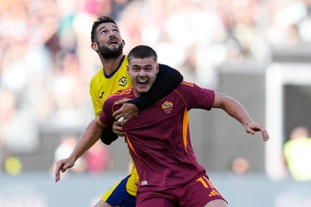 Roberto Gagliardini (Hellas Verona) and Evan Ferguson (AS Roma) battle for the ball, Serie A, AS Roma v Hellas Verona FC, Olimpico Stadium, September 28, 2025, Roma, Italy.