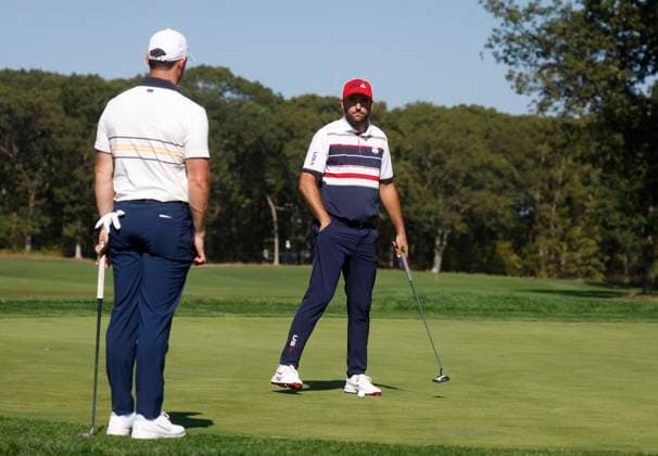 Scottie Scheffler (R) of Team United States and Rory McIlroy of Team Europe prepare to putt on the ninth green during singles match competition on the final day of the 45th Ryder Cup at the Bethpage Black Course in Farmingdale, New York on Sunday, September 28, 2025. Europe has a 12 to 5 lead over the United States going into the final day.  RYD20250928917 COREYxSIPKIN