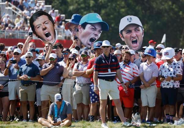 Fans hold cutouts of players on the fifth green during a singles match on the final day of the 45th Ryder Cup at the Bethpage Black Course in Farmingdale, New York on Sunday, September 28, 2025. Europe has a 12 to 5 lead over the United States going into the final day. .J  RYD20250928918 JOHNxANGELILLO