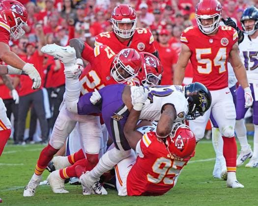 Baltimore Ravens running back Derrick Henry (22) gets tackled for a loss by Kansas City Chiefs defensive end Chris Jones (95) and Kansas City Chiefs defensive back Chamarri Conner (27) at Arrowhead Stadium in Kansas City, Missouri on Sunday, September 28, 2025.  KCP2025092815 JONxROBICHAUD