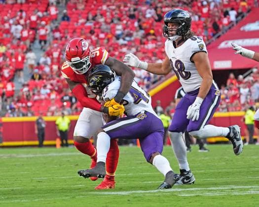 Kansas City Chiefs defensive end Charles Omenihu (90) brings down Baltimore Ravens running back Justice Hill (43) for a 1 yard gain at Arrowhead Stadium in Kansas City, Missouri on Sunday, September 28, 2025.  KCP2025092820 JONxROBICHAUD