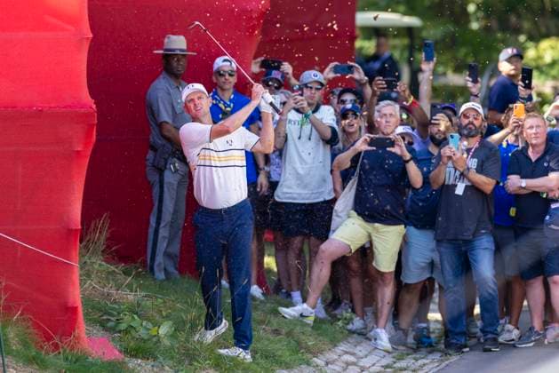 Justin Rose of Team Europe chips back onto the course after his ball landed behind spectator stands during a singles match on the final day of the 45th Ryder Cup at the Bethpage Black Course in Farmingdale, New York on Sunday, September 28, 2025. The Europeans held off a surging United States team to retain the Cup by a score of 15-13.  RYD20250926525 COREYxSIPKIN