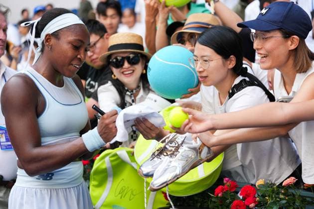 (250930) -- BEIJING, Sept. 30, 2025 -- Coco Gauff (L) signs an autograph after the women s singles fourth round match between Coco Gauff of the United States and Belinda Bencic of Switzerland at 2025 China Open tennis tournament in Beijing, China, Sept. 30, 2025. ) (SP)CHINA-BEIJING-TENNIS-CHINA OPEN-WOMEN S SINGLES-FOURTH ROUND(CN) NaxYuqi 