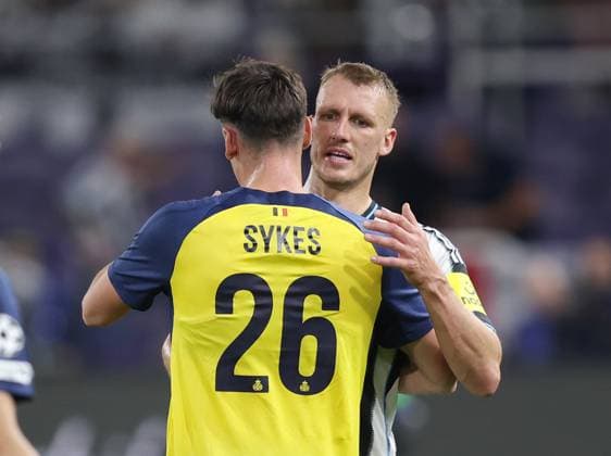 Anderlecht, Belgium, 1st October 2025. Dan Burn of Newcastle United consoles Newcastle fan Ross Sykes of Union Saint-Gilloise during the Union Saint-Gilloise vs Newcastle United UEFA Champions League match at The Constant Vanden Stock Stadium, Anderlecht. Picture credit should read: Paul Terry Sportimage EDITORIAL USE ONLY. No use with unauthorised audio, video, data, fixture lists, club league logos or live services. Online in-match use limited to 120 images, no video emulation. No use in betting, games or single club league player publications. SPI_075_PT_Union_Saint_Gilloise_Newcastle SPI-4179-0075