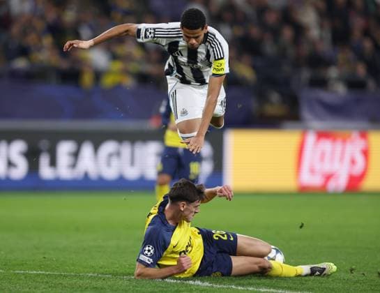 Anderlecht, Belgium, 1st October 2025. William Osula of Newcastle United flies into the air as he evades a tackle from Ross Sykes of Union Saint-Gilloise during the Union Saint-Gilloise vs Newcastle United UEFA Champions League match at The Constant Vanden Stock Stadium, Anderlecht. Picture credit should read: Paul Terry Sportimage EDITORIAL USE ONLY. No use with unauthorised audio, video, data, fixture lists, club league logos or live services. Online in-match use limited to 120 images, no video emulation. No use in betting, games or single club league player publications. SPI_077_PT_Union_Saint_Gilloise_Newcastle SPI-4179-0077