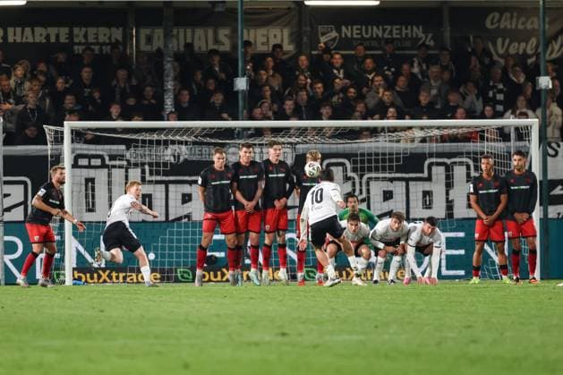 3 Liga SC Verl FC Ingolstadt 04 Free kick Taz Berkan 10 Verl Wall holds Simon Lorenz 32, FCI Jonas Scholz 15, FCI Frederik Christensen 11, FCI Max Plath 14 FCI Goalkeeper Kai Eisele 25, FCI 3 Liga FC Ingolstadt 04 Season 2025 2026 SC Verl