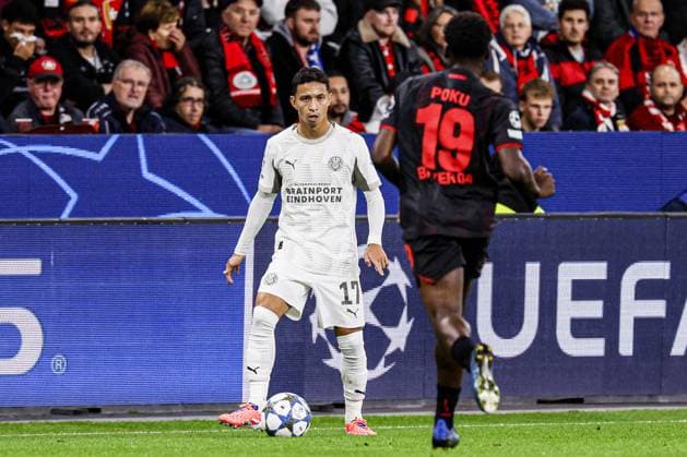 Mauro Junior of PSV Eindhoven battles for possession with Ernest Poku of Bayer 04 Leverkusen Bayer 04 Leverkusen v PSV Eindhoven, UEFA Champions League 2025 26 League Phase MD2, Bayer 04 Leverkusen v PSV Eindhoven, BayArena, October 1, 2025, Leverkusen, Germany.