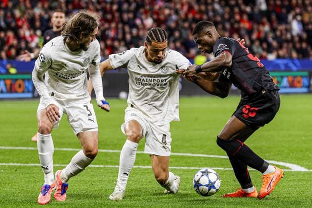 Christian Kofane of Bayer 04 Leverkusen battles for possession with Armando Obispo of PSV Eindhoven and Yarek Gasiorowski of PSV Eindhoven Bayer 04 Leverkusen v PSV Eindhoven, UEFA Champions League 2025 26 League Phase MD2, Bayer 04 Leverkusen v PSV Eindhoven, BayArena, October 1, 2025, Leverkusen, Germany.