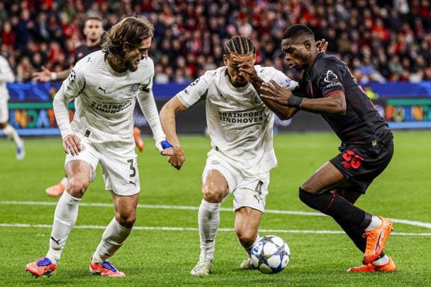 Christian Kofane of Bayer 04 Leverkusen battles for possession with Armando Obispo of PSV Eindhoven and Yarek Gasiorowski of PSV Eindhoven Bayer 04 Leverkusen v PSV Eindhoven, UEFA Champions League 2025 26 League Phase MD2, Bayer 04 Leverkusen v PSV Eindhoven, BayArena, October 1, 2025, Leverkusen, Germany.