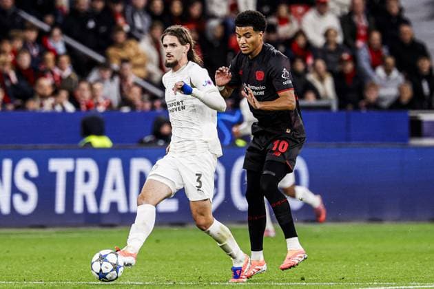 Yarek Gasiorowski of PSV Eindhoven battles for possession with Malik Tillman of Bayer 04 Leverkusen Bayer 04 Leverkusen v PSV Eindhoven, UEFA Champions League 2025 26 League Phase MD2, Bayer 04 Leverkusen v PSV Eindhoven, BayArena, October 1, 2025, Leverkusen, Germany.