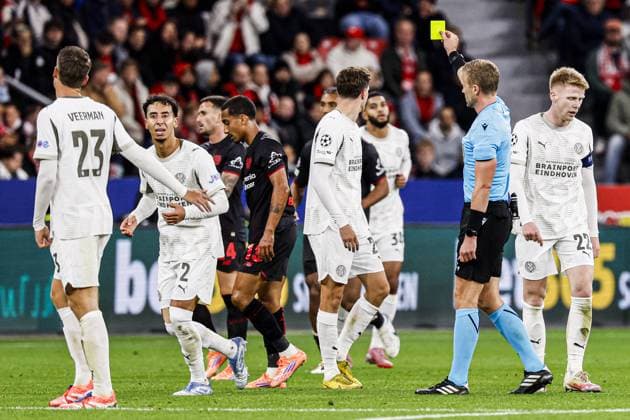 Referee Glenn Nyberg shows a yellow card to Guus Til of PSV Eindhoven Bayer 04 Leverkusen v PSV Eindhoven, UEFA Champions League 2025 26 League Phase MD2, Bayer 04 Leverkusen v PSV Eindhoven, BayArena, October 1, 2025, Leverkusen, Germany.