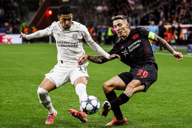 Alejandro Grimaldo of Bayer 04 Leverkusen battles for possession with Mauro Junior of PSV Eindhoven Bayer 04 Leverkusen v PSV Eindhoven, UEFA Champions League 2025 26 League Phase MD2, Bayer 04 Leverkusen v PSV Eindhoven, BayArena, October 1, 2025, Leverkusen, Germany.