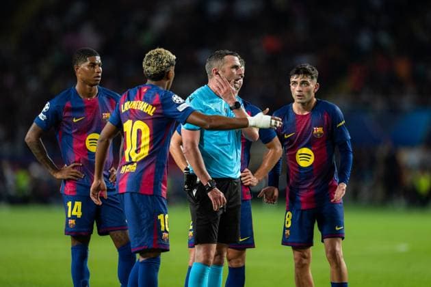 Spain-Football-Champions League-Group Stage FC Barcelona, Barca v PSG in Barcelona, Spain. Barcelona, Spain, 1, October, 2025. FC Barcelona players with the referee Michael Olivier during Champions League match between FC Barcelona and PSG in Olympic Stadium Lluis Companys, Barcelona, Spain, on October 1, 2025. Barcelona Olympic Stadium Lluis Companys Barcelona Spain