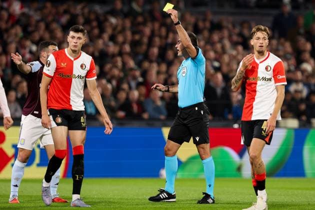 2025-10-02 Feyenoord v Aston Villa - UEFA Europa League, League phase, MD2 ROTTERDAM, NETHERLANDS - OCTOBER 2: Referee Rade Obrenovic shows the yellow card to Anel Ahmedhodzic of Feyenoord during the UEFA Europa League, League phase, MD2 match between Feyenoord and Aston Villa at Stadion Feijenoord on October 2, 2025 in Rotterdam, Netherlands. Rotterdam Stadion Feijenoord Netherlands Content not available for redistribution in The Netherlands directly or indirectly through any third parties. Copyright: xHansxvanxderxValkx