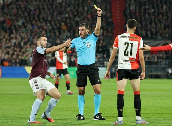 Referee Rade Obrenovic shows a yellow card to Anel Ahmedhodzic of Feyenoord as John McGinn of Aston Villa reacts Feyenoord v Aston Villa, UEFA Europa League, Group Stage, Football, De Kuip, Rotterdam, Netherlands - 02 Oct 2025Rotterdam De Kuip Netherlands EDITORIAL USE ONLY No use with unauthorised audio, video, data, fixture lists, club league logos or live services. Online in-match use limited to 120 images, no video emulation. No use in betting, games or single club league player publications. Copyright: xBartxStoutjesdijk Shutterstockx 15504059ab