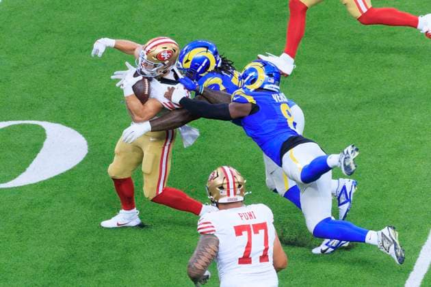 October 2, 2025, Inglewood, California, USA: 57 Ty Hamilton, DT and 8 Jared Verse, LB of the Los Angeles Rams pull on the collar of 23 Christian McCaffrey, RB of the San Francisco 49ers during their regular NFL, American Football Herren, USA season game on Thursday October 2, 2025 at SoFi Stadium in Inglewood, California. Rams lose to 49ers, 23-26. ARIANA RUIZ PI Inglewood USA - ZUMAp124 20251002_zaa_p124_071 Copyright: xArianaxRuizx