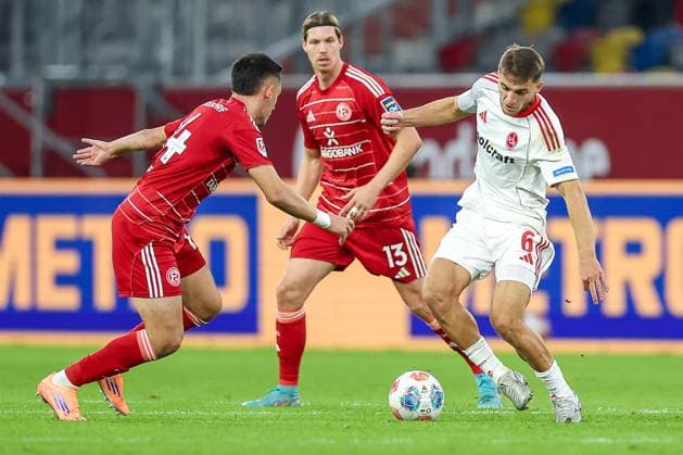 03 10 2025, Football, Fortuna Düsseldorf 1 FC Nuremberg, 2 Fußball Bundesliga, Merkur Spiel Arena, Saison 2025 2026 Sotiris Alexandropoulos Fortuna Düsseldorf 14 in duel against Florian Flick 1FC Nuernberg 06 DFB regulations prohibit any use of photographs as image sequences and or quasi video Nordrhein Westfalen Germany