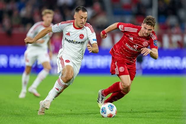03 10 2025, Football, Fortuna Düsseldorf 1 FC Nürnberg, 2 Fußball Bundesliga, Merkur Spiel Arena, Saison 2025 2026 Julian Justvan 1FC Nuernberg 10 in duel against Moritz Heyer Fortuna Düsseldorf 05 DFB regulations prohibit any use of photographs as image sequences and or quasi video Nordrhein Westfalen Germany
