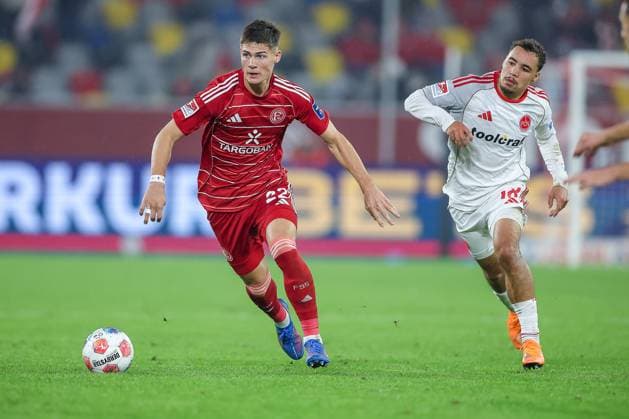 03 10 2025, Football, Fortuna Düsseldorf 1 FC Nuremberg, 2 Fußball Bundesliga, Merkur Spiel Arena, Saison 2025 2026 Danny Schmidt Fortuna Düsseldorf 22 in duel against Rafael Lubach 1FC Nuernberg 18 DFB regulations prohibit any use of photographs as image sequences and or quasi video Nordrhein Westfalen Germany