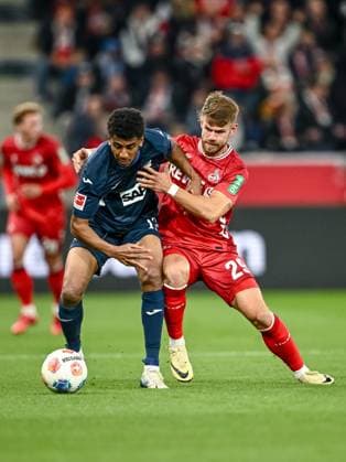 Bernardo (1899 Hoffenheim) und Jan Thielmann (1. FC Köln) im Zweikampf waehrend des spiels der Bundesliga zwischen TSG Hoffenheim und 1. FC Köln, PreZero Arena am 03. October 2025 in Sinsheim, Deutschland. (Foto von Harry Langer DeFodi Images) +++ Bernardo (1899 Hoffenheim) und Jan Thielmann (1. FC Köln) battle for the ball during the Bundesliga match between TSG Hoffenheim and 1. FC Köln at PreZero Arena on October 3, 2025 in Sinsheim, Germany. (Photo by Harry Langer DeFodi Images) DFL regulations prohibit any use of photographs as image sequences and or quasi-video. (Photo by Harry Langer DeFodi Images) DFL regulations prohibit any use of photographs as image sequences and or quasi-video. Bernardo 1899 Hoffenheim and Jan Thielmann 1 FC Köln in a duel during the Bundesliga match between TSG Hoffenheim and 1 FC Köln, PreZero Arena on 03 October 2025 in Sinsheim, Germany Photo by Harry Langer DeFodi Images Bernardo 1899 Hoffenheim and Jan Thielmann 1 FC Köln battle for the ball during the Bundesliga match between TSG Hoffenheim and 1 FC Köln at PreZero Arena on October 3, 2025 in Sinsheim, Germany Photo by Harry Langer DeFodi Images DFL regulations prohibit any use of photographs as image sequences and or quasi video Photo by Harry Langer DeFodi Images DFL regulations prohibit any use of photographs as image sequences and or quasi video
