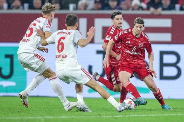03 10 2025, Football, Fortuna Düsseldorf 1 FC Nürnberg, 2 Fußball Bundesliga, Merkur Spiel Arena, Saison 2025 2026 Tim Drexler 1FC Nuernberg 15 Florian Flick 1FC Nuernberg 06 in duel against Cedric Itten Fortuna Düsseldorf 13 DFB regulations prohibit any use of photographs as image sequences and or quasi video Nordrhein Westfalen Germany