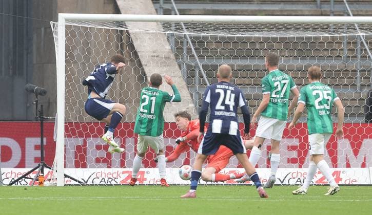 Sebastian Grönning scores the goal for 1 0 against goalkeeper Johannes Schenk duel Match scene Action Sport Soccer Football DFL 2 Bundesliga Men 8 Matchday Season 2025 2026 04 10 2025 Hertha BSC Berlin vs Preußen Münster DFL regulations prohibit any use of photographs as image sequences and or quasi video
