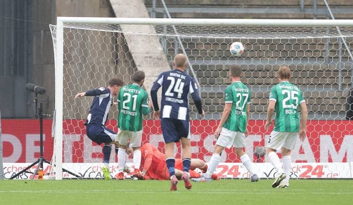 Sebastian Grönning scores the goal for 1 0 against goalkeeper Johannes Schenk duel Match scene Action Sport Soccer Football DFL 2 Bundesliga Men 8 Matchday Season 2025 2026 04 10 2025 Hertha BSC Berlin vs Preußen Münster DFL regulations prohibit any use of photographs as image sequences and or quasi video