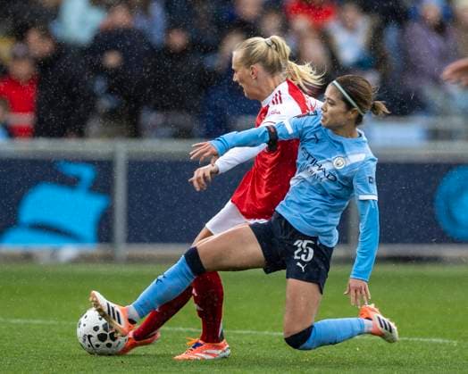 4th October 2025; Joie Stadium, Manchester, England; Womens Super League Football, Manchester City versus Arsenal; Stina Blackstenius of Arsenal Women is tackled by Yui Hasegawa of Manchester City Women  TimxWilliams