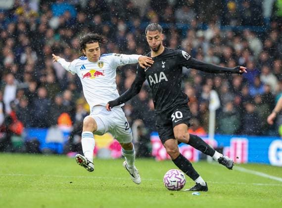 Leeds, England, 4th October 2025. Ao Tanaka (L) of Leeds United in action with Rodrigo Bentancur of Tottenham Hotspur during the Leeds United vs Tottenham Hotspur Premier League match at Elland Road, Leeds. Picture credit should read: Nigel Roddis Sportimage EDITORIAL USE ONLY. No use with unauthorised audio, video, data, fixture lists, club league logos or live services. Online in-match use limited to 120 images, no video emulation. No use in betting, games or single club league player publications. SPI_019_NR_LEED_TOTE SPI-4193-0019
