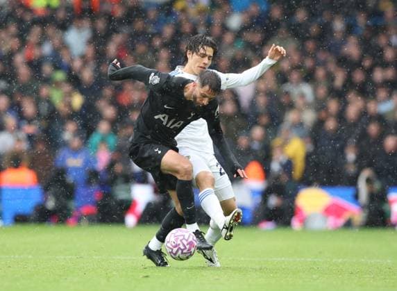 Leeds, England, 4th October 2025. Ao Tanaka (R) of Leeds United in action with Rodrigo Bentancur of Tottenham Hotspur during the Leeds United vs Tottenham Hotspur Premier League match at Elland Road, Leeds. Picture credit should read: Nigel Roddis Sportimage EDITORIAL USE ONLY. No use with unauthorised audio, video, data, fixture lists, club league logos or live services. Online in-match use limited to 120 images, no video emulation. No use in betting, games or single club league player publications. SPI_023_NR_LEED_TOTE SPI-4193-0024