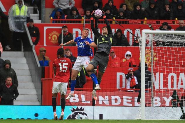 4th October 2025; Old Trafford, Manchester, England; Premier League Football, Manchester United, ManU versus Sunderland; Senne Lammens of Manchester United leaps to claim a cross under pressure from Daniel Ballard of Sunderland  DavidxBlunsden